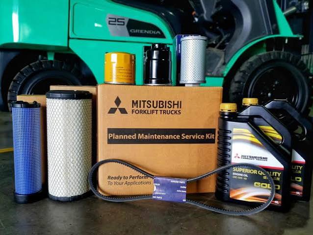 Forklift service technician working on industrial equipment